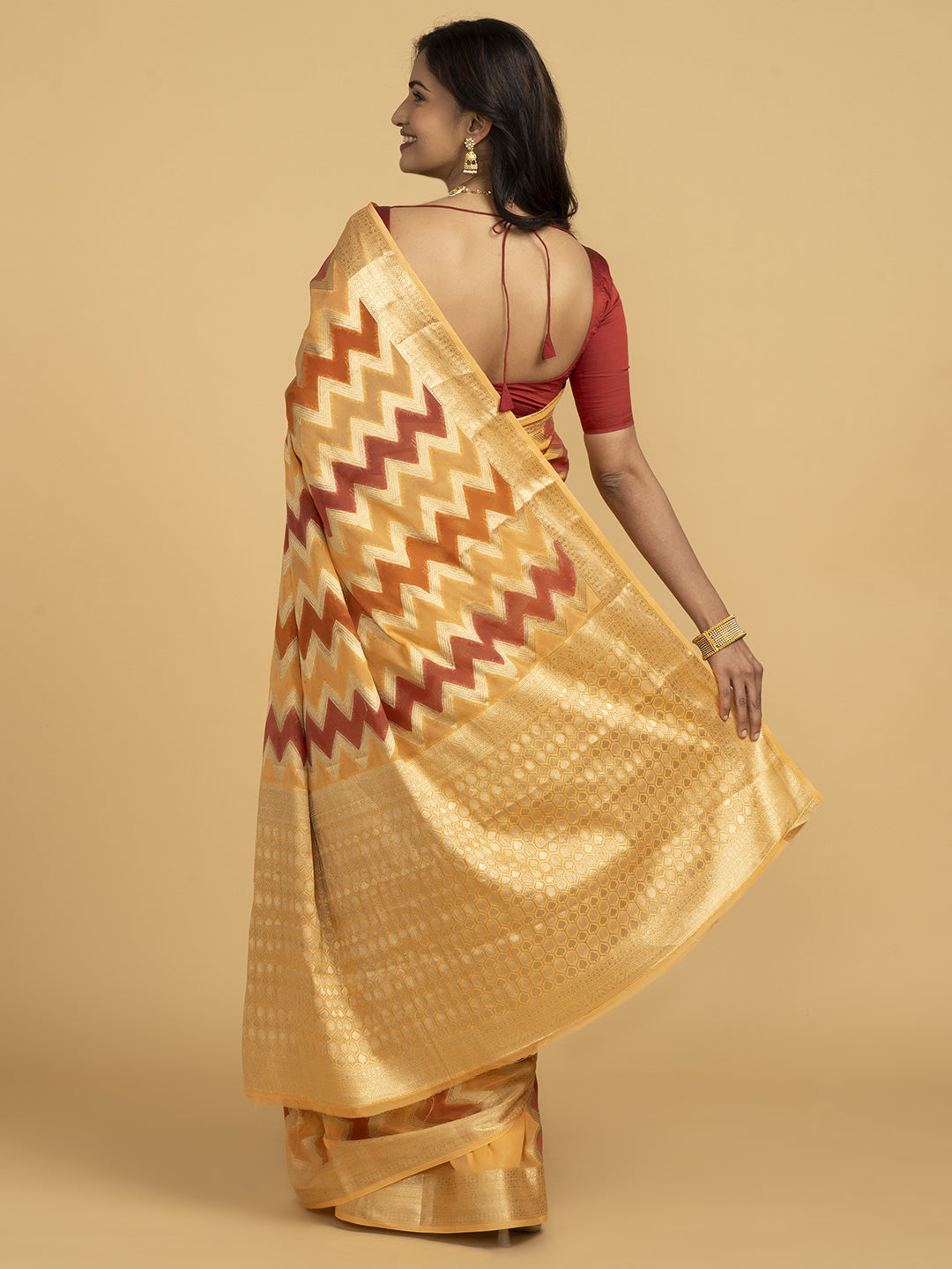 Divine Drapes Ikat Design Peach And Gold Saree